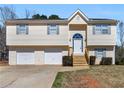 Inviting two-story home featuring a 2-car garage, new roof, and charming front entrance with new wood steps at 195 Brighton Dr, Covington, GA 30016