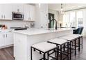 Modern kitchen with a large island, stylish pendant lights, and bar stool seating at 337 Skylar Se Way, Atlanta, GA 30315