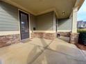 View of the cozy covered front porch with stone base columns and accent wall at 42 Champions Crossing, Villa Rica, GA 30180