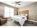 Cozy bedroom with a queen-sized bed, a window, a recliner, and neutral tones at 2541 Kickerillo Se Way, Atlanta, GA 30316