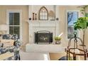 Cozy living room with a white brick fireplace, mantel, and natural light, creating a warm atmosphere at 4753 Outlook Ne Way, Marietta, GA 30066