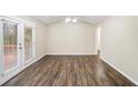 Cozy dining room featuring wood floors, modern light fixture, and access to a deck at 6510 Connell Rd, Atlanta, GA 30349