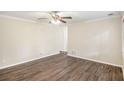 Inviting living room features stylish flooring, crown molding, and a modern ceiling fan at 6510 Connell Rd, Atlanta, GA 30349