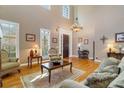 Sunlit living room featuring a tall ceiling, hardwood floors, and stylish furnishings at 1835 Leighton Ne Ln, Marietta, GA 30062