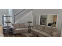 Comfortable living room with hardwood floors, neutral colors, and staircase at 3416 Haddon Hall Ct, Buford, GA 30519