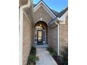 Inviting front entrance with decorative glass door and brick archway with beautiful sidelights at 828 Cedar Stream Ct, Loganville, GA 30052