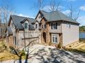A stately home with a two-car garage and view of the lake at 1401 Rainey Rd, Temple, GA 30179