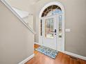 Bright entryway features a white front door, wood floors, and white trim at 1401 Rainey Rd, Temple, GA 30179
