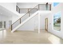 Bright foyer with hardwood floors, a staircase, and natural light from a large window at 1650 Eastport Se Ter, Atlanta, GA 30317