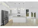 Modern white kitchen featuring a center island, stainless steel appliances, and ample cabinet space at 1650 Eastport Se Ter, Atlanta, GA 30317