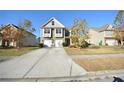 Charming two-story home with a double garage, surrounded by a well-maintained lawn and mature trees at 2453 Osceola Rd, Lithonia, GA 30058