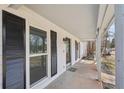 Inviting front porch with white siding, dark shutters, and a welcoming entrance at 489 Natasha Dr, Auburn, GA 30011