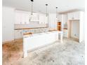 Spacious kitchen featuring white cabinets, center island, pantry, and modern vent hood, ready for appliances at 1269 Pj East Rd, Covington, GA 30014