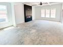 Bright living room with black fireplace, tray ceiling, and large windows allowing natural light to fill the space at 1269 Pj East Rd, Covington, GA 30014
