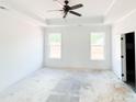 Bright main bedroom featuring tray ceiling and windows providing lots of natural light at 1269 Pj East Rd, Covington, GA 30014