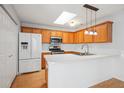Bright kitchen features wood cabinets, white countertops, stainless steel appliances, and skylight at 134 Rose Cottage Ln, Woodstock, GA 30189