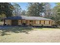 Attractive single-story home with an attached garage and inviting front yard landscaping at 3948 Lake Carlton Road S Rd, Loganville, GA 30052