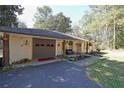 This home features an attached garage and a cozy front patio area at 3948 Lake Carlton Road S Rd, Loganville, GA 30052