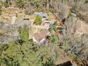 A bird's eye view of the property, showcasing the expansive yard, mature trees, and neighborhood at 4648 Danna Dr, Austell, GA 30106