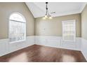 Bright dining room with hardwood floors, wainscoting, and natural light at 494 Martin Forest Ln, Lawrenceville, GA 30045