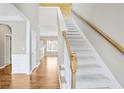 Inviting foyer with hardwood floors, staircase, and view of the kitchen at 494 Martin Forest Ln, Lawrenceville, GA 30045