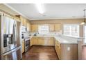 Spacious kitchen with stainless steel appliances, wooden cabinets and hardwood flooring at 494 Martin Forest Ln, Lawrenceville, GA 30045