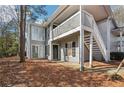 Charming exterior elevation of a two-story home with gray siding, a front door, and an exterior staircase at 101 Natchez Trce, Atlanta, GA 30350