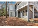 Inviting exterior elevation of a two-story home with gray siding, a front door and an exterior staircase at 101 Natchez Trce, Atlanta, GA 30350