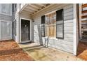 Close-up of the front entrance featuring a black door, exterior light, and a window with shutters at 101 Natchez Trce, Atlanta, GA 30350