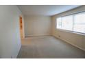 Bright, carpeted bedroom with a large window, neutral walls, and ample natural light at 4042 Shady Nw Cir, Lilburn, GA 30047