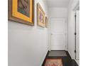 Hallway featuring artwork and a clean aesthetic, leading to various rooms within the home at 1421 Peachtree Ne St # 415, Atlanta, GA 30309