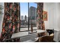 Stunning city views framed by decorative curtains, offering a glimpse of the urban landscape at 1421 Peachtree Ne St # 415, Atlanta, GA 30309