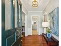 Elegant entryway features hardwood floors, stylish lighting, and a view to the kitchen at 1664 West Wesley Nw Rd, Atlanta, GA 30327
