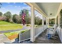 Inviting front porch with stone floor and rocking chairs offers a relaxing outdoor space at 1664 West Wesley Nw Rd, Atlanta, GA 30327