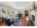 Bright living room features hardwood floors, a cozy fireplace, and large windows at 1664 West Wesley Nw Rd, Atlanta, GA 30327