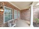 Cozy porch with brick walls and a white column, perfect for enjoying quiet moments outdoors at 970 Prance Dr, Kennesaw, GA 30144