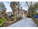 Craftsman home with a long driveway, mature trees and a quaint covered porch at 313 5Th Ne St, Atlanta, GA 30308