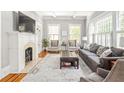 Bright living room with a fireplace, built-in shelving, and large windows at 313 5Th Ne St, Atlanta, GA 30308