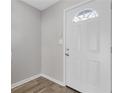 Bright entryway featuring new hardwood flooring and a modern white front door at 5940 Hampton Ct, Atlanta, GA 30349