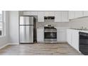 Updated kitchen with stainless steel appliances, sleek countertops, and ample cabinet space at 5940 Hampton Ct, Atlanta, GA 30349
