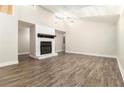 Bright living room featuring a cozy fireplace, modern flooring, vaulted ceilings and plenty of natural light at 9515 Deerfield Ln, Jonesboro, GA 30238