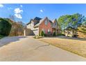 Attractive home with a long driveway leading to a spacious two-car garage at 4005 Princeton Trce, Cumming, GA 30041