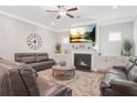 Comfortable living room with a cozy fireplace, built-in shelving, and plush leather seating at 145 Treeside Ter, Fayetteville, GA 30214