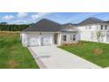 Beautiful single-story home featuring a two-car garage and a concrete driveway at 246 Orwell Dr, Social Circle, GA 30025