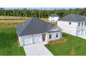Newly built single-story home with a spacious front yard and a two-car garage at 246 Orwell Dr, Social Circle, GA 30025