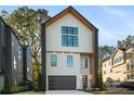 Striking two-story home featuring a black garage door and modern design elements at 3206 Osborne Ne Rd, Brookhaven, GA 30319