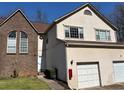 Two-story townhome with brick and siding exterior, attached garage, and manicured front yard at 705 Bridge Se Ln, Smyrna, GA 30082