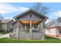 Inviting front porch with wood ceiling, swing, and brick foundation at 1147 Oakland Sw Dr, Atlanta, GA 30310