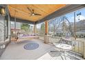 Relaxing front porch with wood ceiling, fan, swing, chair, and neighborhood view at 1147 Oakland Sw Dr, Atlanta, GA 30310