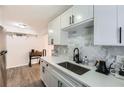 Modern kitchen with sleek white cabinets, stainless steel appliances, and updated fixtures and marble backsplash at 1284 Piedmont Ne Ave # 12, Atlanta, GA 30309